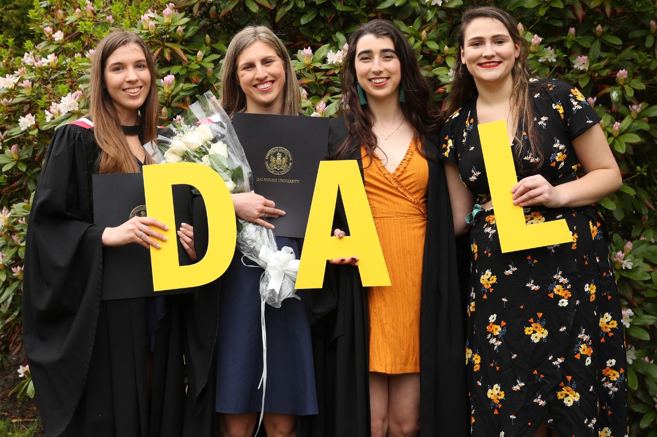 Students holding DAL letters at convocation