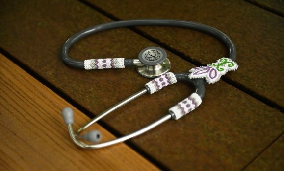 A black stethoscope with traditional Mi'kmaq beading on it.