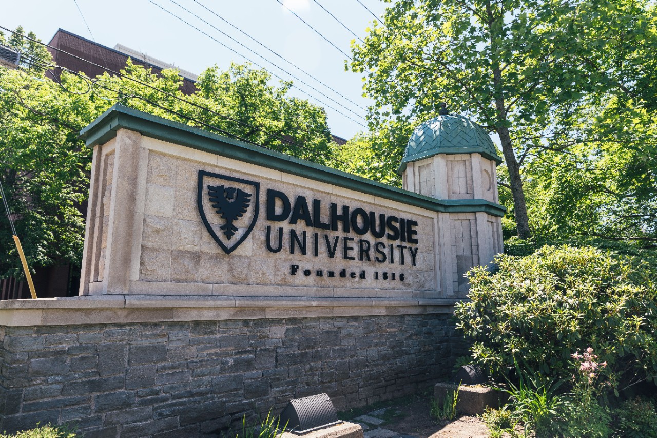 A stone sign says Dalhousie University Founded 1818 next to an eagle crest.