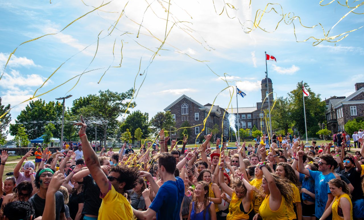 A joyful crowd of students celebrating O-Week on the quad