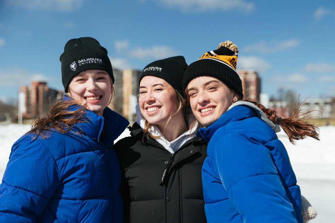 three students at the oval in winter