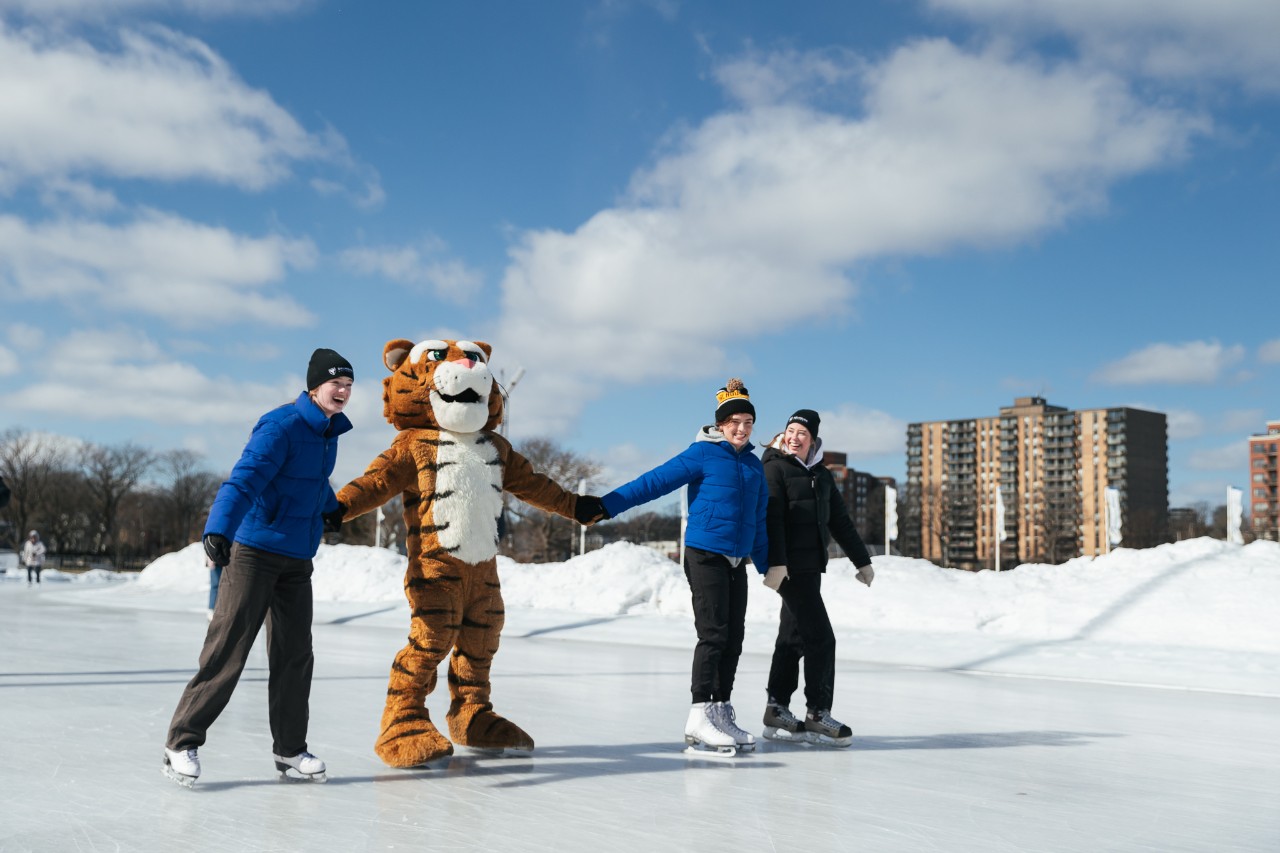 students and tiger mascot ice skating