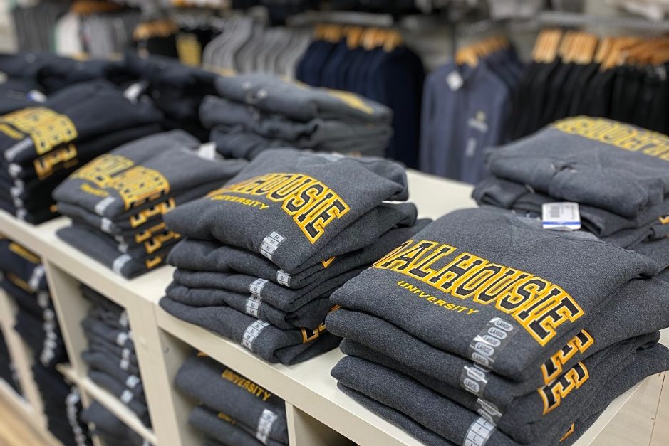 Stack of Dalhousie-branded sweaters for sale.