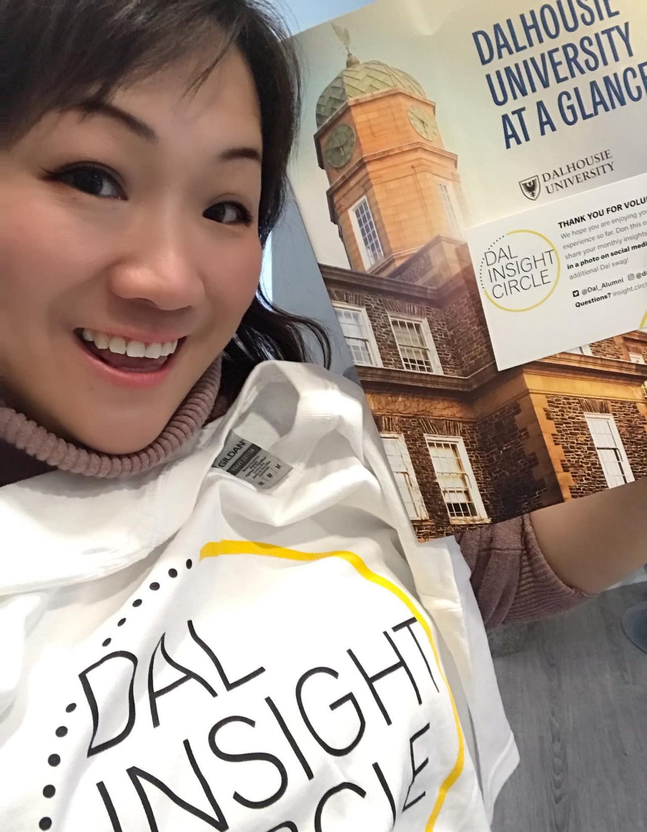 Choi-Cheung smiling with Dal Insight Circle t-shirt and pamphlet.