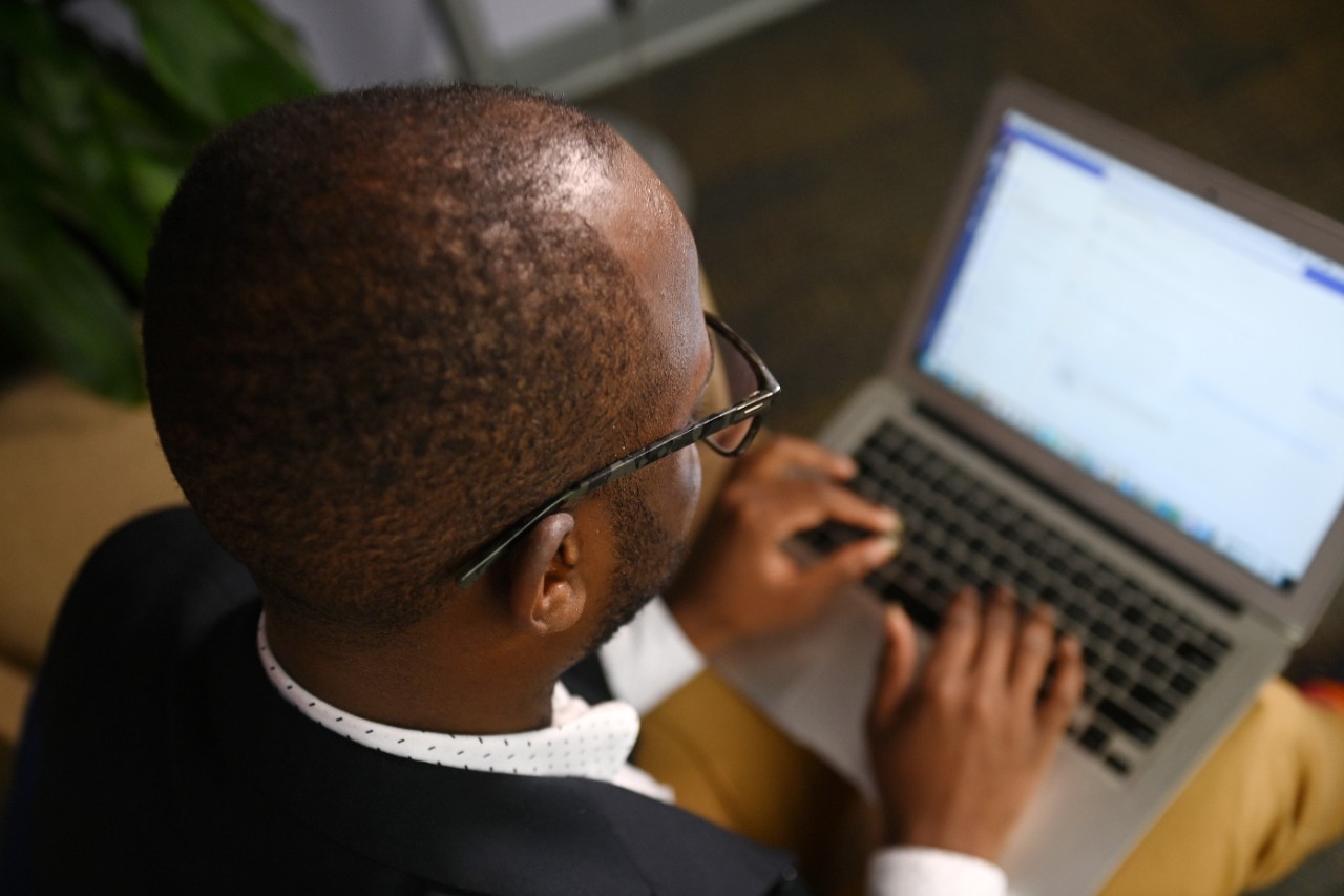 Overhead of a person working on a laptop.